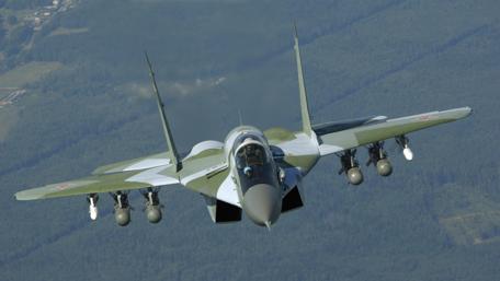 Military Aircraft in Action Above the Landscape wallpaper