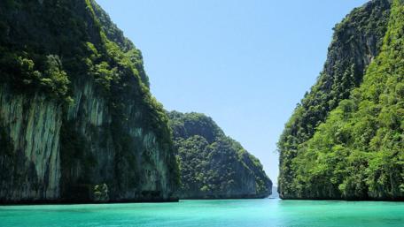Majestic Cliffs Embrace Azure Waters wallpaper