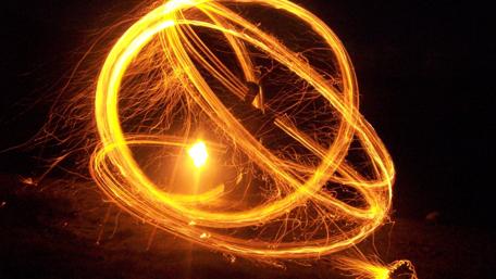 Radiant Swirls of Light Dance in Darkness wallpaper
