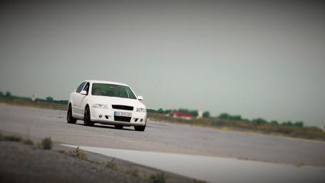 Sleek White Car on a Runway Field wallpaper