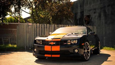 Sleek Black Chevy with Bold Orange Accents wallpaper