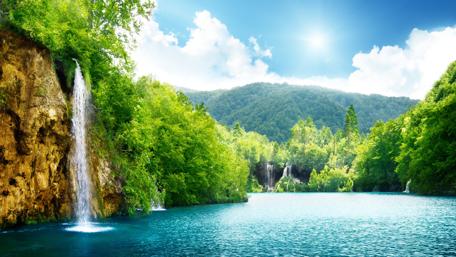 Cascade of Serenity in Lush Greenlands wallpaper
