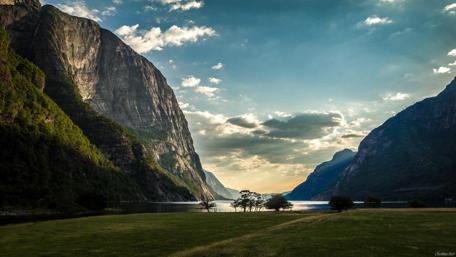 Majestic Fjord Landscape with Dramatic Mountains and Serene Waters wallpaper