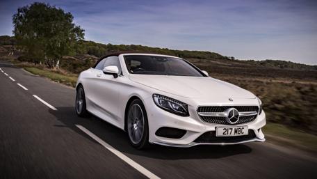 Sleek Mercedes-Benz Driving Through Scenic Landscape wallpaper