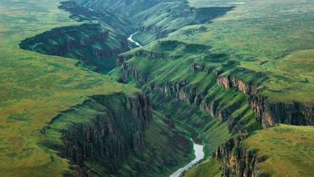 Majestic River Carving Through Lush Valleys wallpaper