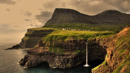 Majestic Waterfall Cascading into the Ocean wallpaper