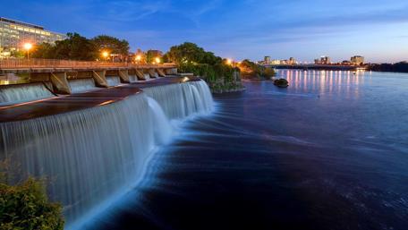Urban Oasis with Majestic Waterfall wallpaper