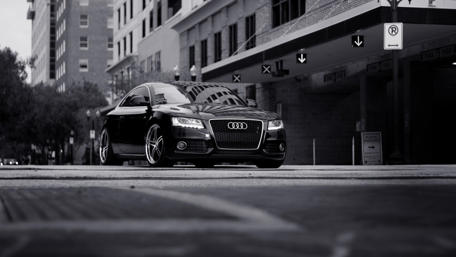 Sleek Monochrome Audi in Urban Setting wallpaper