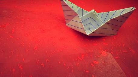 Paper Boat on a Vibrant Red Background wallpaper
