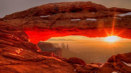 Majestic Sunset Through Natural Archway wallpaper