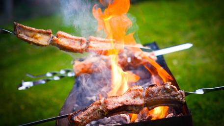 Sizzling Grilled Meat Over Fiery Flames wallpaper