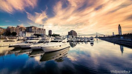 Serene Cityscape Reflected in Water at Dusk wallpaper