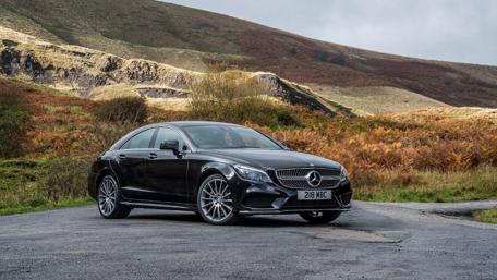Sleek Black Dream Car in Scenic Landscape wallpaper