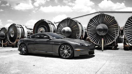 Sleek Monochrome Car Against Industrial Backdrop wallpaper