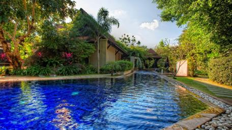 Serene Cottage Pool Surrounded by Lush Greenery and Tranquility wallpaper
