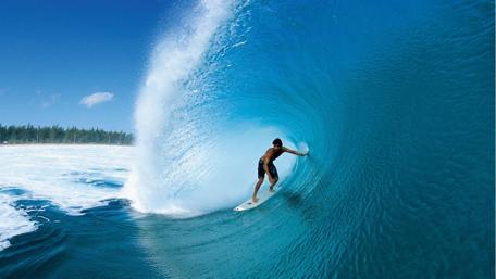 Thrilling Surfing Adventure in Crystal Clear Waves wallpaper