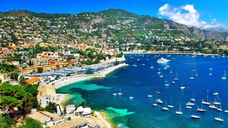 Breathtaking Coastal City View with Mountains and Blue Waters wallpaper