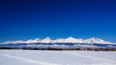 Majestic Snow-Capped Mountains Under Clear Blue Sky wallpaper