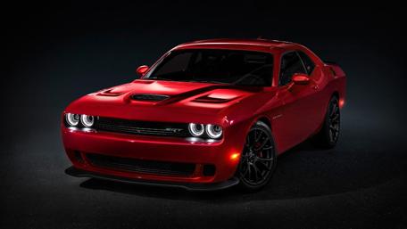 Sleek Red Muscle Car in the Spotlight wallpaper