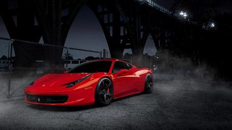 Sleek Red Sports Car Under Urban Lights wallpaper
