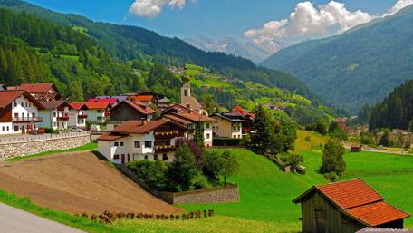 Tranquil Village Amidst Scenic Mountains wallpaper