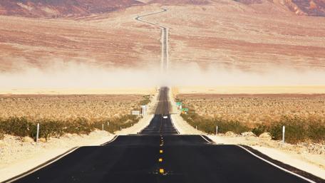 Endless Road Through Arid Landscape wallpaper