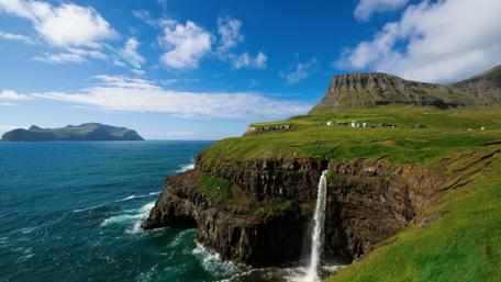Majestic Waterfall Cascading into the Sea wallpaper