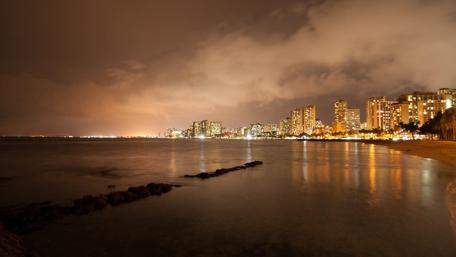 City Lights Reflecting on Water at Night wallpaper