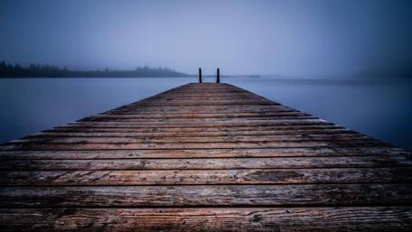 Serene Wooden Pier in Misty Nature Scene wallpaper