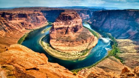 Majestic River Curving Through Desert Cliffs wallpaper