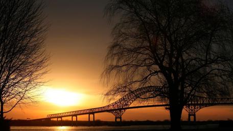 Golden Sunset Over a Bridge and Trees wallpaper