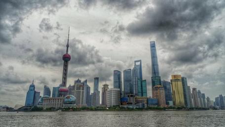 Shanghai Skyline Under Dramatic Clouds in 4K Resolution wallpaper