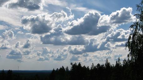 Majestic Cloudscapes Over Tranquil Forests wallpaper