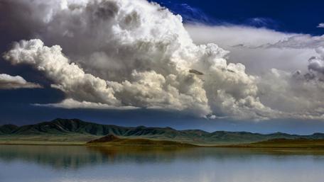 Majestic Clouds Over Tranquil Lake wallpaper