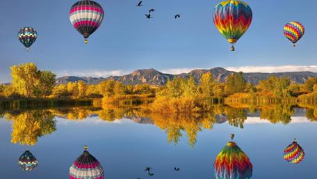 Colorful Hot Air Balloons Over Serene Lake Scene wallpaper