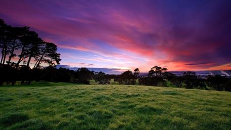 Vibrant Sunset Over Rolling Hills wallpaper