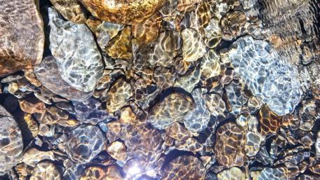 Glittering Stones Beneath Water Surface wallpaper