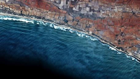Coastal Serenity in Vibrant Blues and Earthy Tones wallpaper