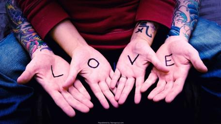 Expressive Love Through Tattooed Hands wallpaper