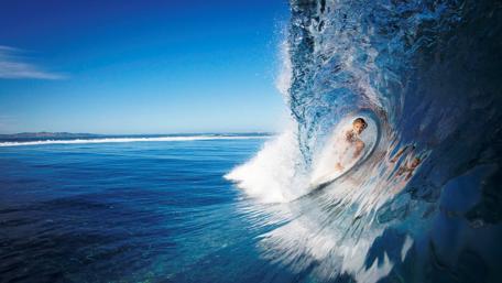 Thrilling Surfing Adventure in a Perfect Wave wallpaper