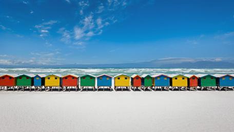 Colorful Beach Huts by the Shoreline wallpaper