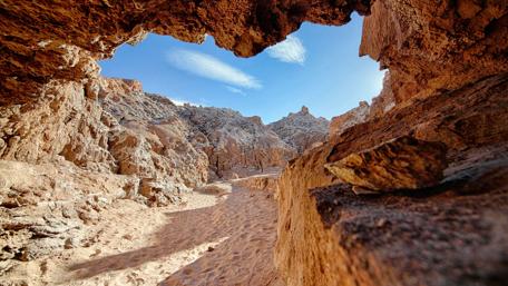 Desert Cave View Under Bright Sky wallpaper