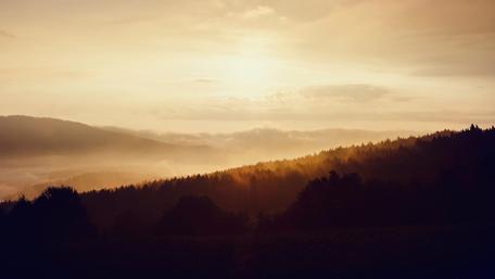 Golden Sunset Over Misty Mountains wallpaper