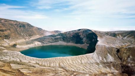Majestic Volcanic Crater with Turquoise Water wallpaper