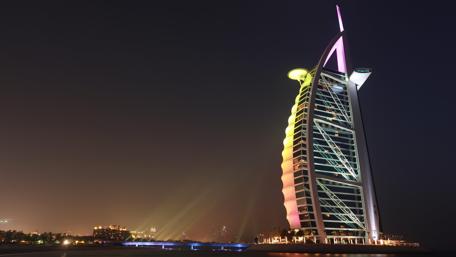 Vibrant Nightscape of a Modern City Towering Icon wallpaper