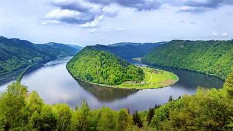 Serene Riverbend in Lush Green Hillside Views wallpaper