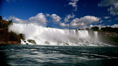 Majestic Waterfall Under a Bright Sky wallpaper