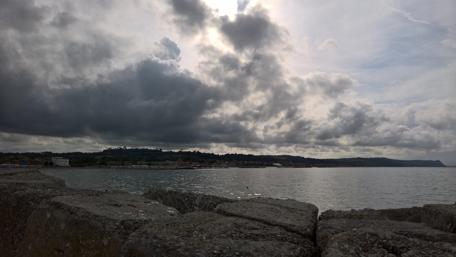 Serene Coastal Views Under Dramatic Skies wallpaper