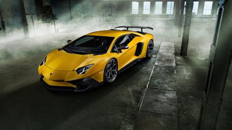 Sleek Yellow Lamborghini in Industrial Setting wallpaper