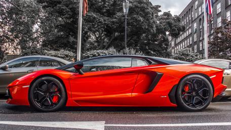 Sleek Red Lamborghini Aventador in Urban Setting wallpaper